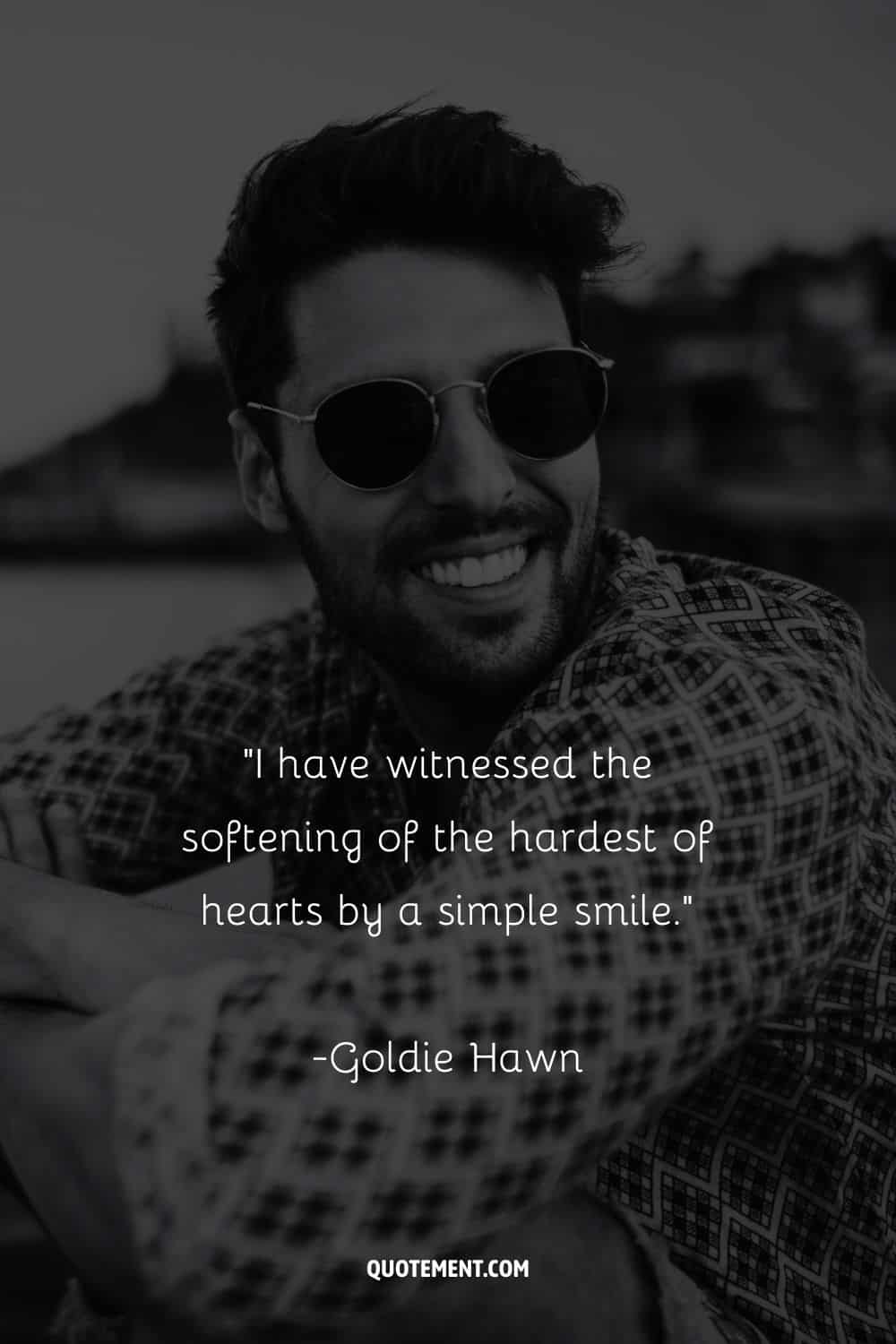 a man with cool sunglasses smiling representing beautiful quote about smiles
