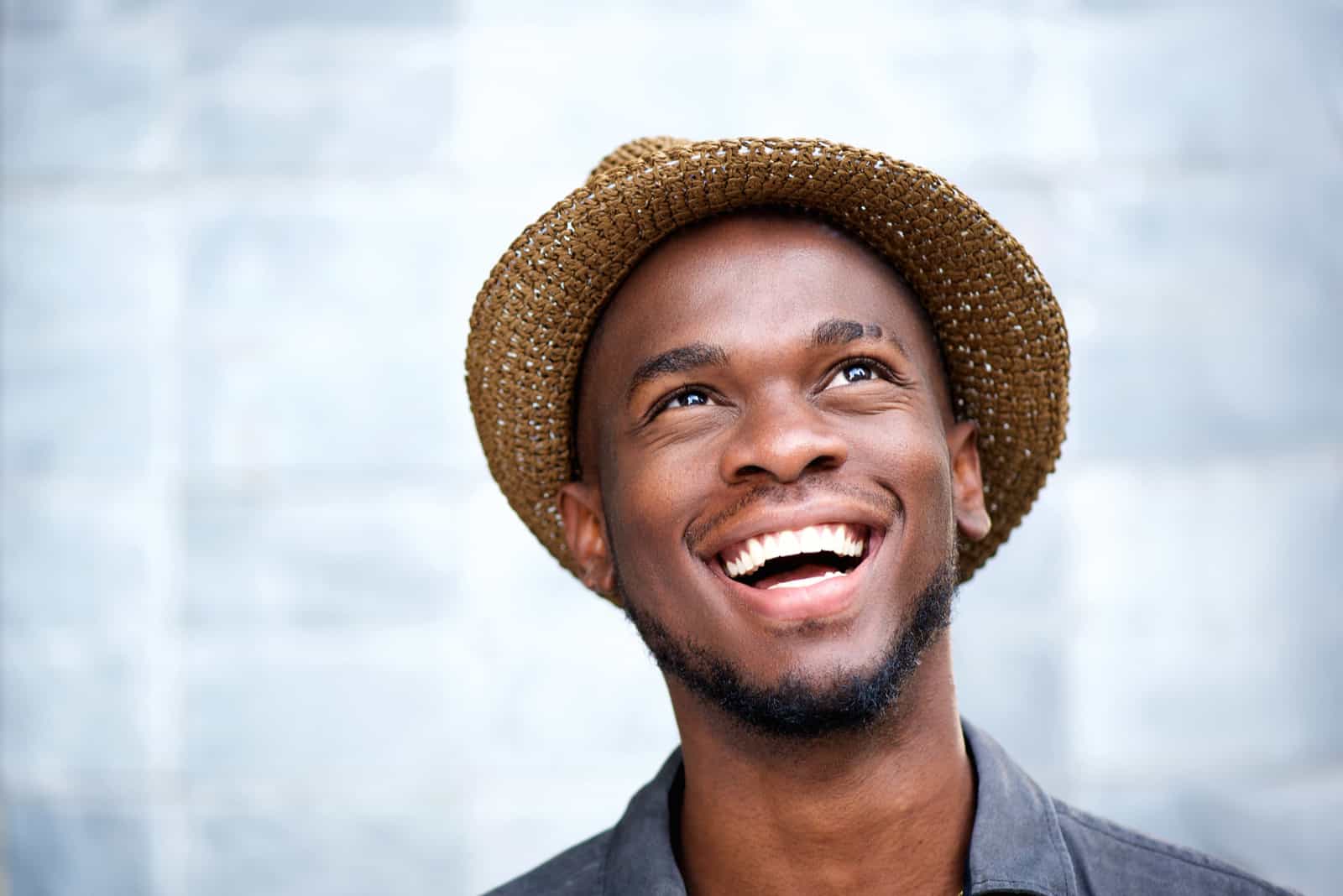 a smiling man with a hat on his head
