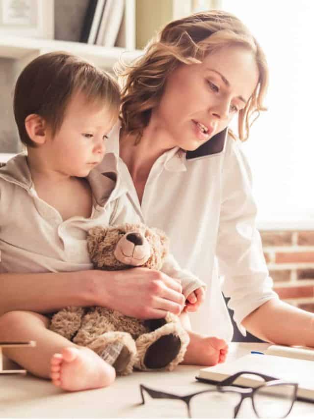 mother working and holding her baby at the same time