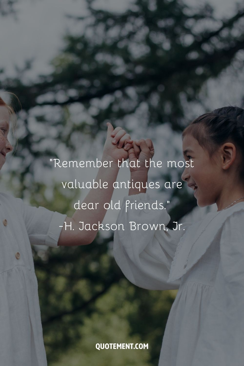 two girls in white shirts share engage in a heartwarming pinkie promise
