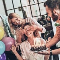 smiling woman celebrating birthday with friends