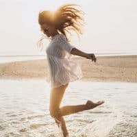 a smiling girl enjoys the sea beach