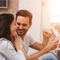 Young Couple sitting on the floor and looking at each other