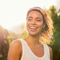 happy woman enjoying sunny day outdoors