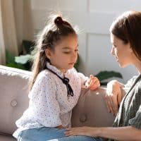 mom and daughter sitting in living room and talking