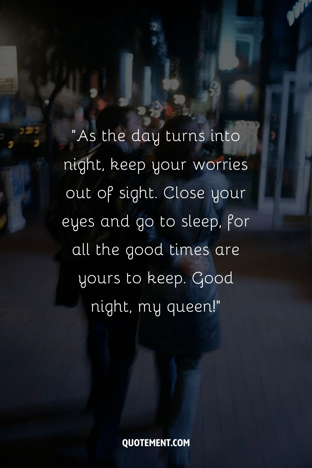 A blurred image of a couple walking at night with city lights in the background
