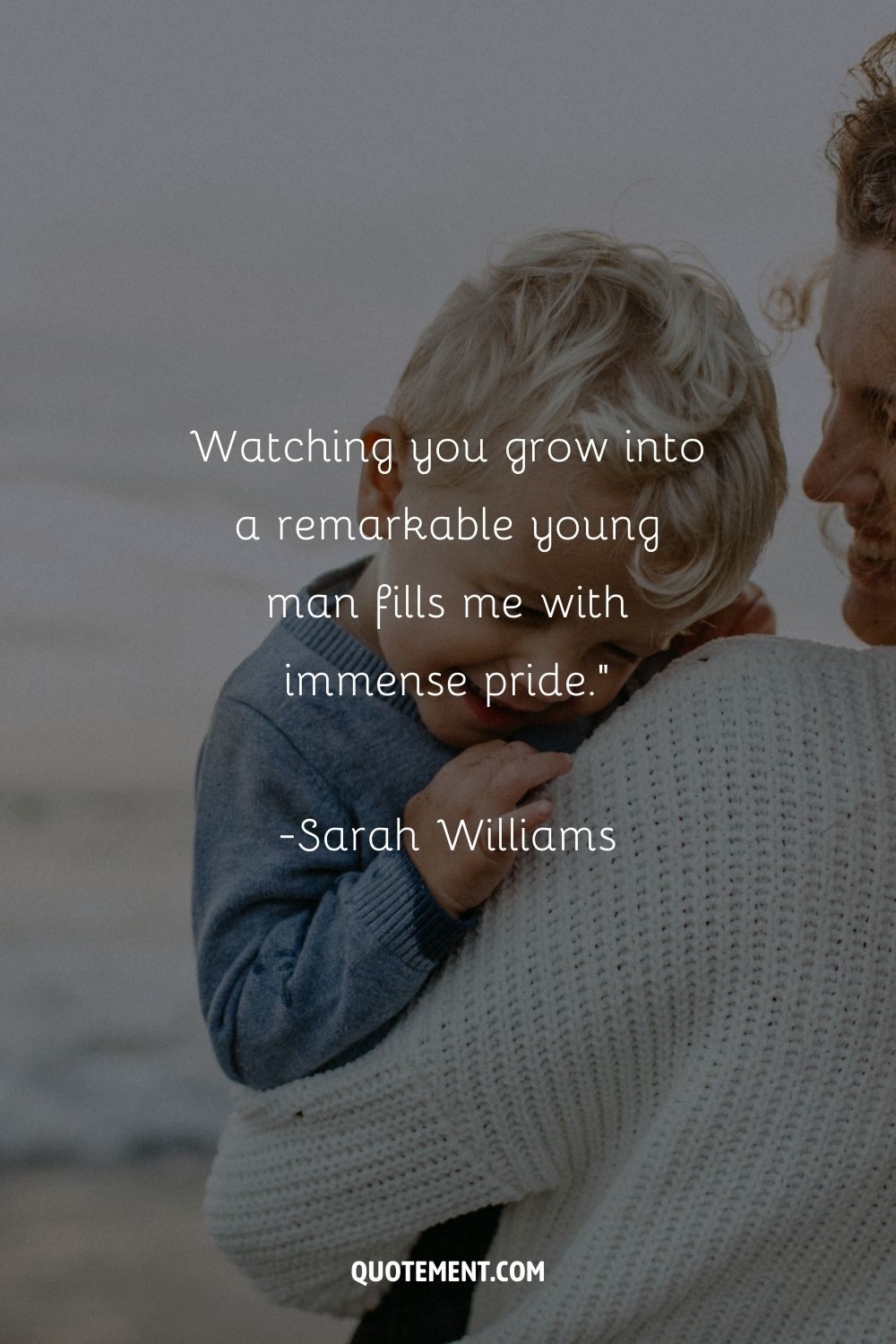 A close-up of a young boy resting on a woman's shoulder