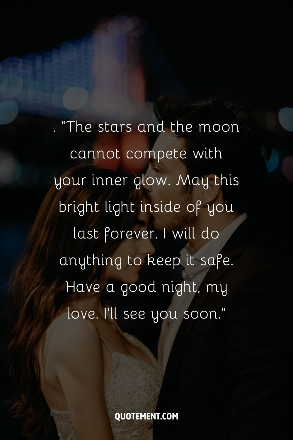 A couple close together at night, with illuminated city lights providing a soft backdrop