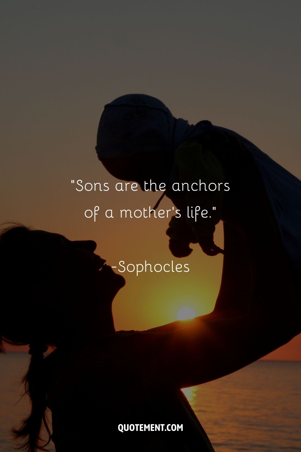A silhouette of a woman lifting a young child into the air against a sunset over the ocean