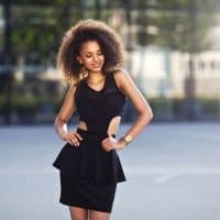 beautiful natural young African woman smiling standing on the street