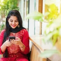 Pretty young indian woman using her phone