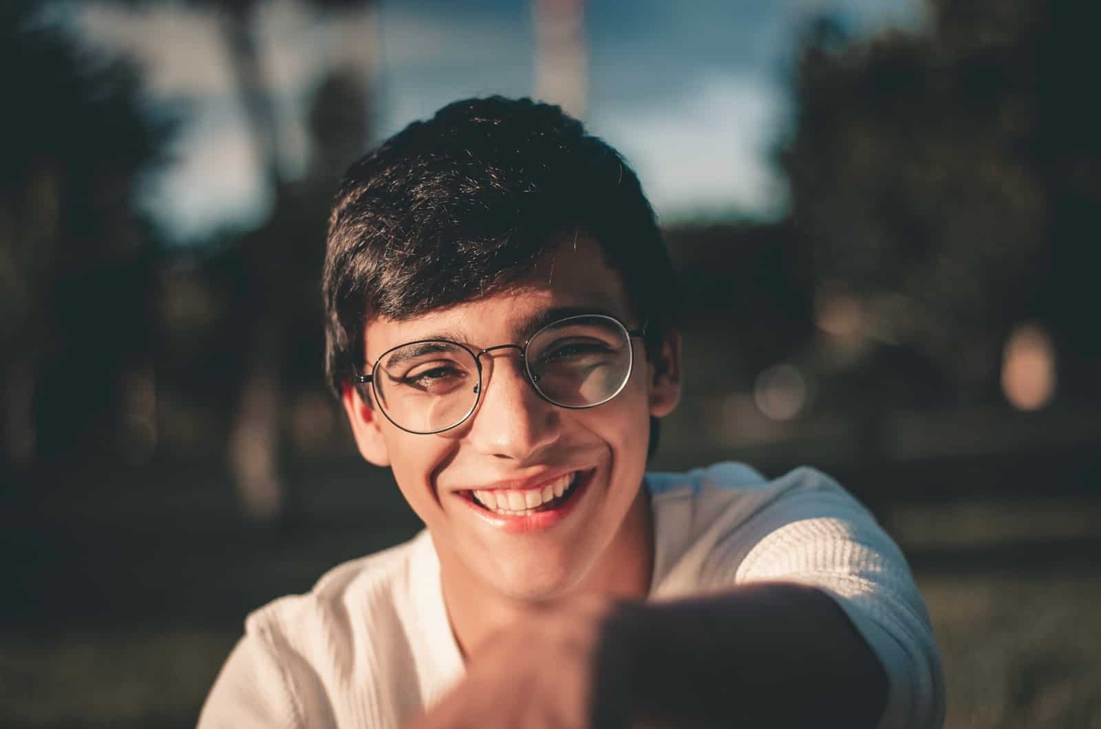 smiling young man with glasses