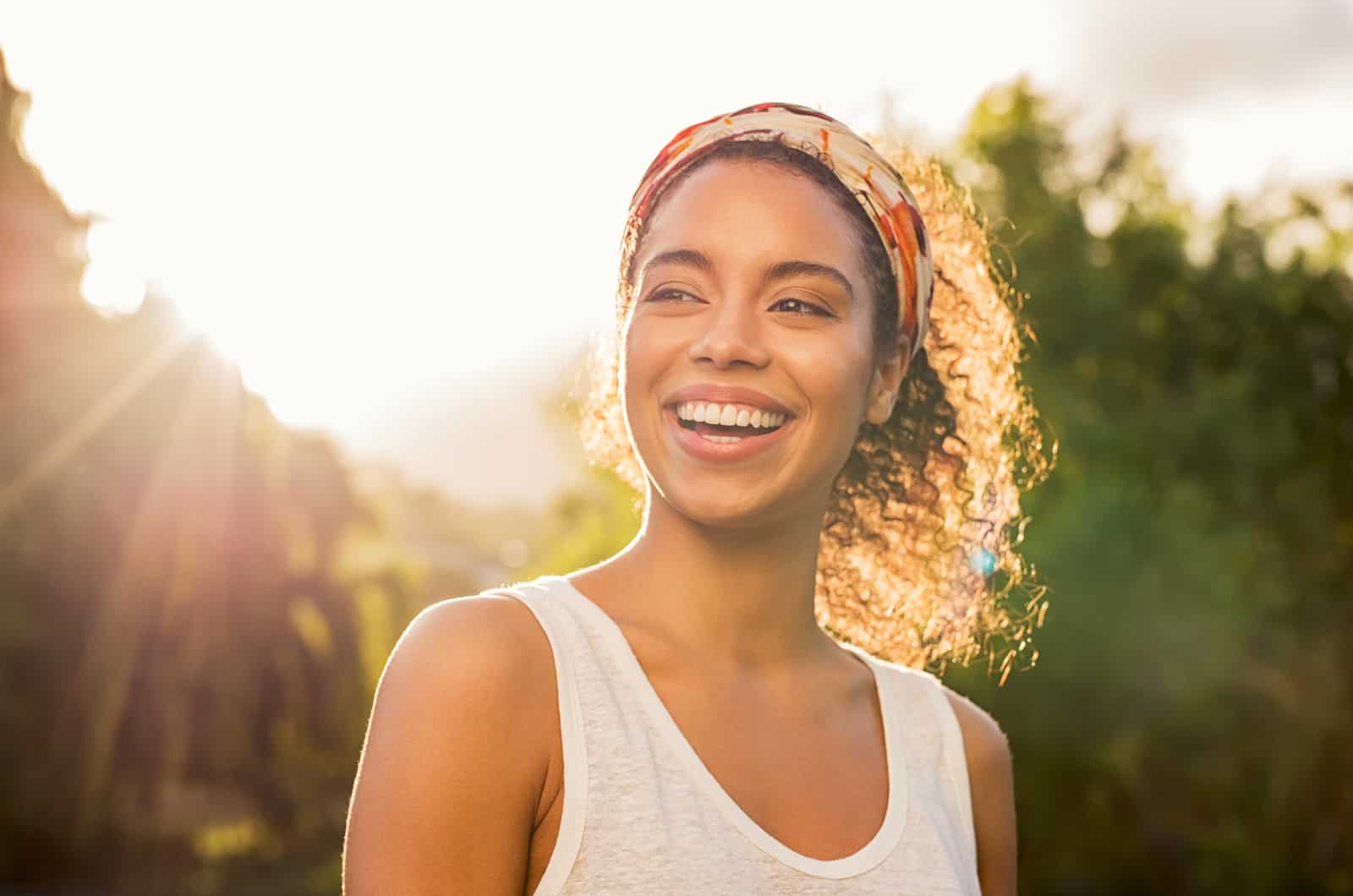 woman smiling outside at sunset