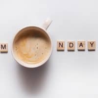 wooden letters and cup of coffee on a white background