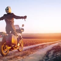 man riding his bike on dusty road