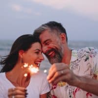 happy couple holding little fireworks