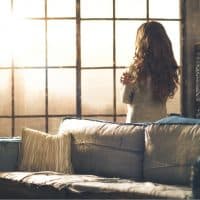 woman standing in front of window