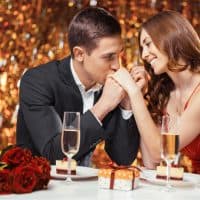 smiling man and woman sitting at a romantic dinner