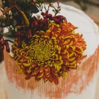 orange and white cake with decoration on table