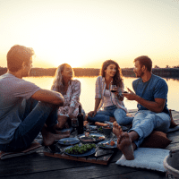 friends sit on the pier and talk