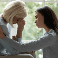 daughter comforting her sad mother