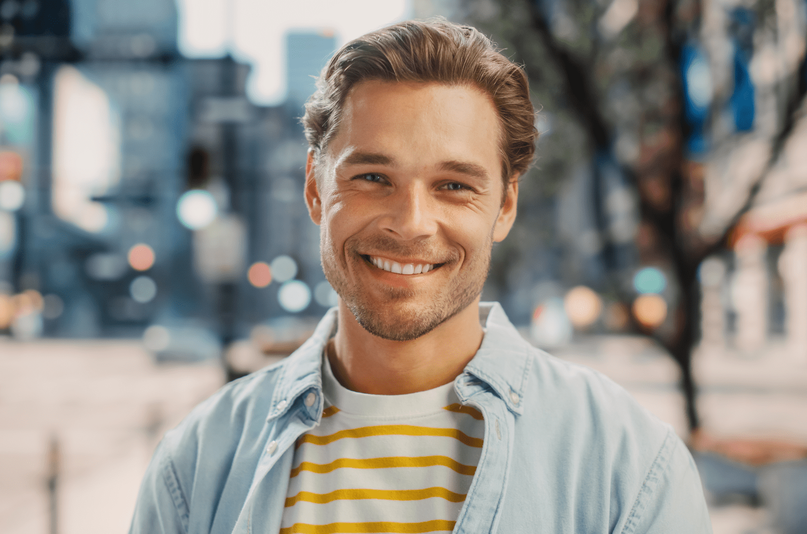 a smiling man standing outdoors