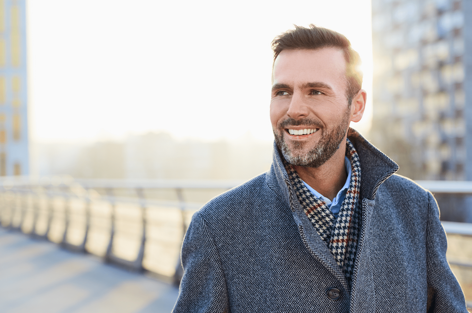 a smiling man walks down the street