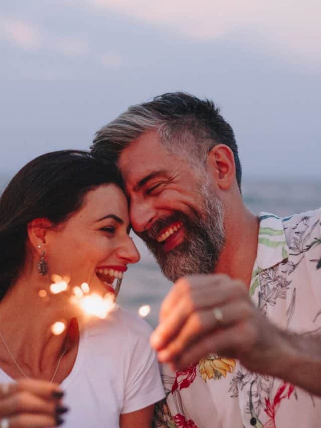 happy couple holding little fireworks
