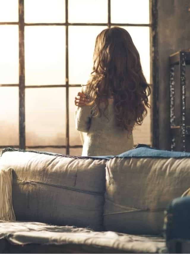 woman standing in front of window
