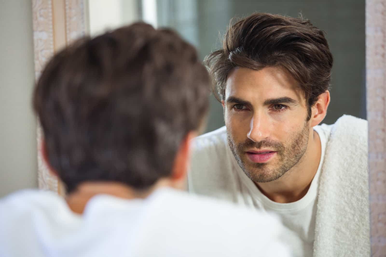 man looking into mirror