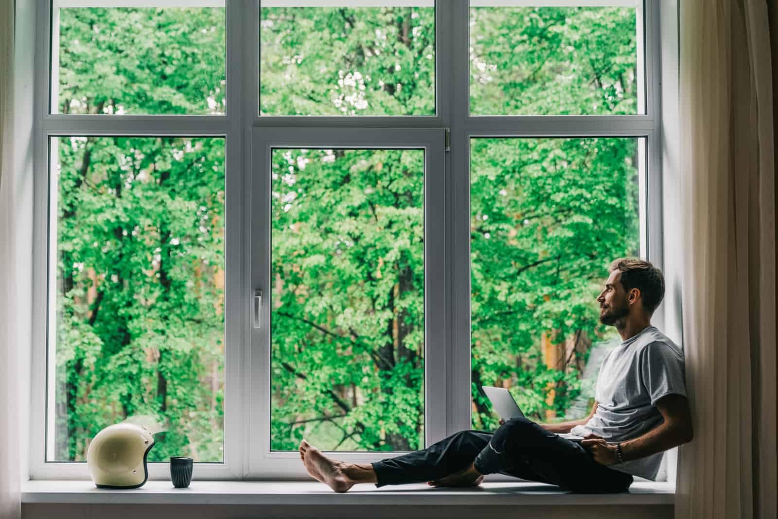 man sitting by window