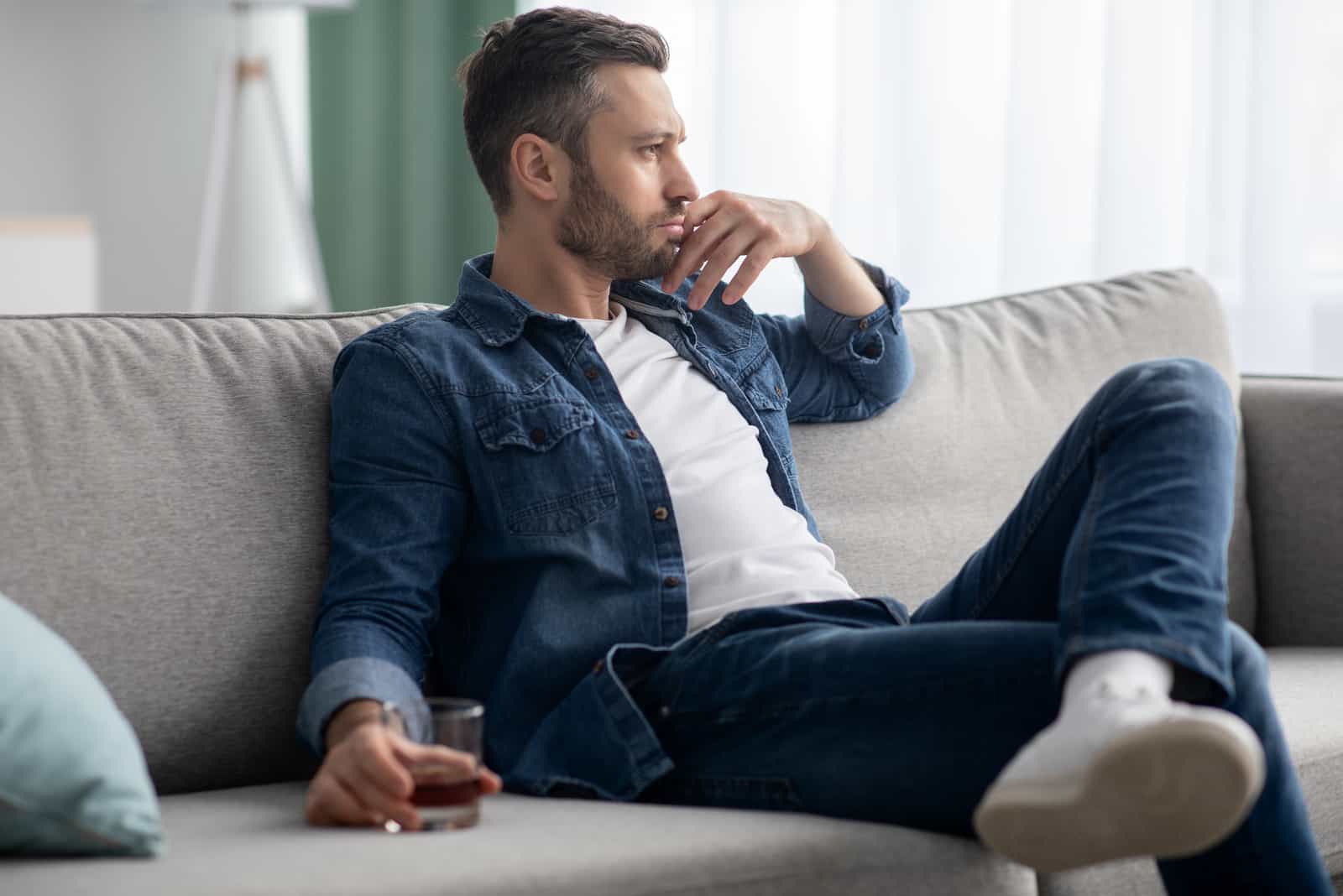 man sitting on sofa