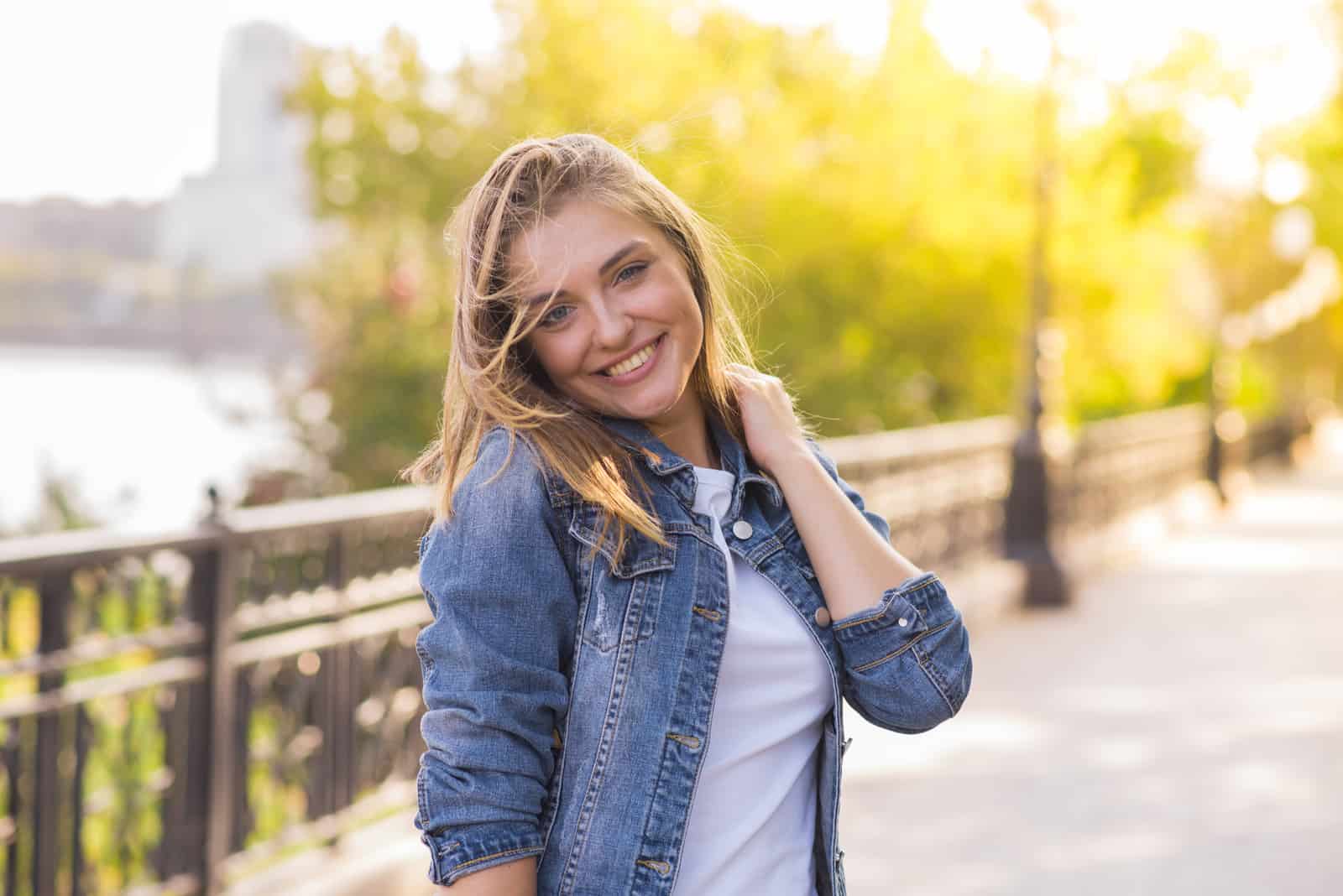 mujer sonriente posando en la calle