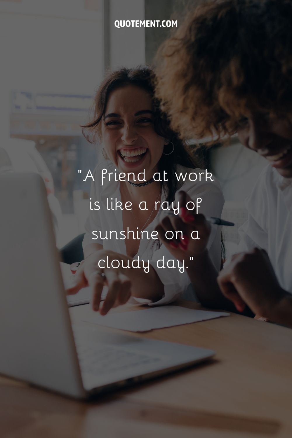 two colleagues laughing together representing work friend quote
