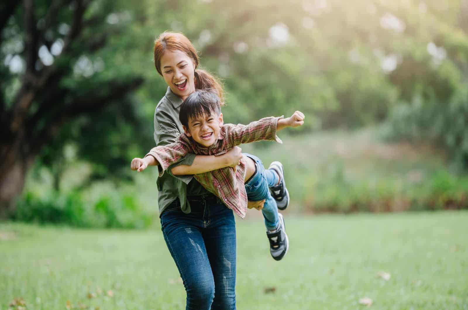 young woman playing with little boy