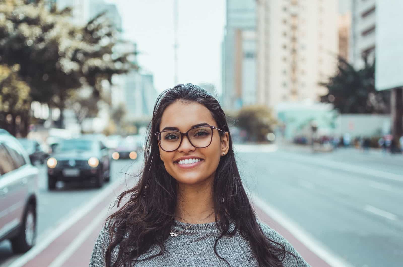 young woman with glasses smiling