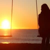 woman sitting alone on a swing