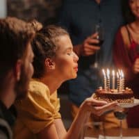 woman blowing candles