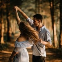 man and woman dancing in nature
