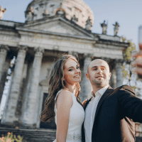 a man and a woman take a picture at a wedding