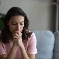 sad woman sitting indoors