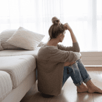 sad woman sitting on the floor