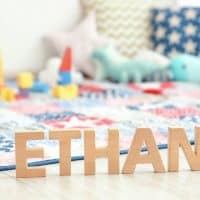 name ETHAN composed of wooden letters on floor