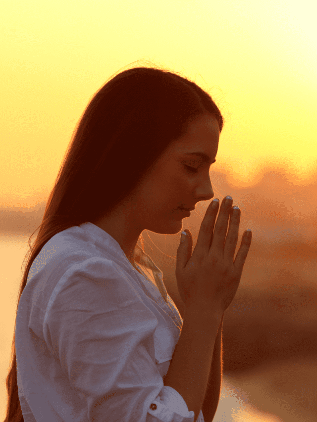 a woman with long brown hair is praying