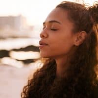 calm woman with closed eyes standing outdoor