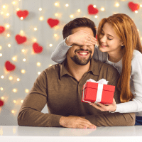 a beautiful woman surprised a man with a gift