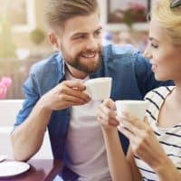 Woman with man drinking coffee together