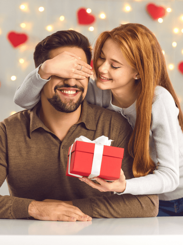 a beautiful woman surprised a man with a gift