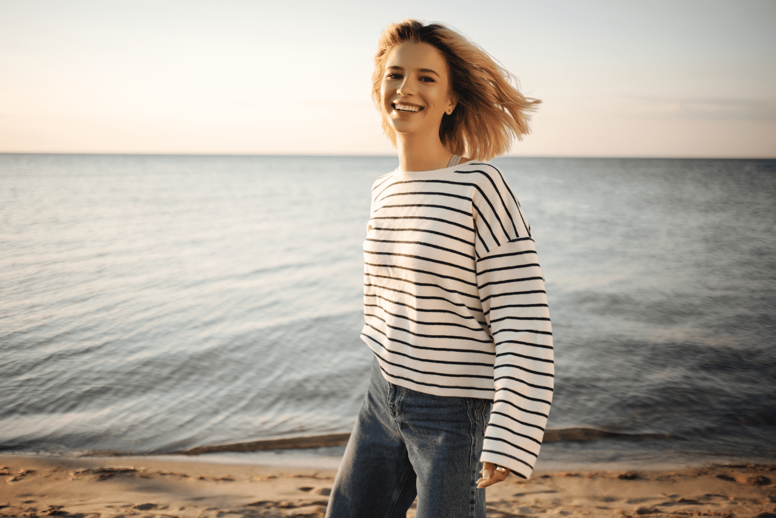 smiling woman standing on the beach