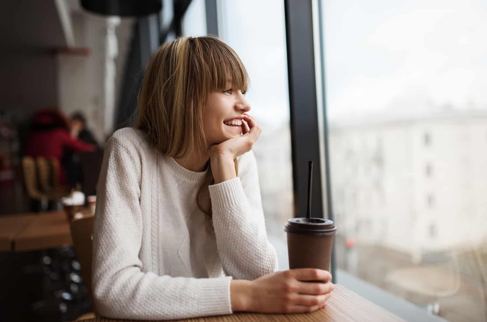 happy girl sitting in cafe